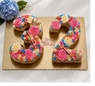 Number 32 cake decorated with colorful buttercream flowers